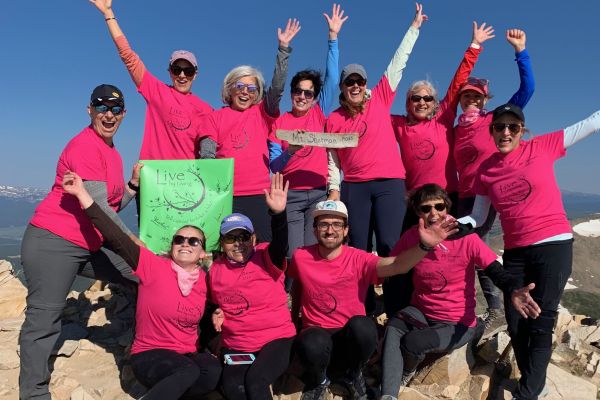 SOCO survivors wearing pink shirts proudly show off their achievement of climbing to the top of Mt. Sherman during a CA to 14k event.