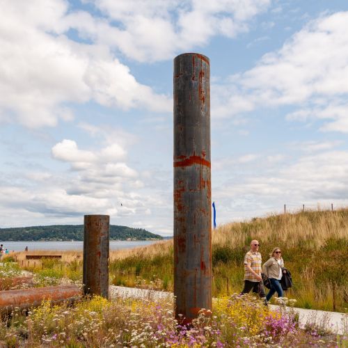 Steel pipe sculpture with Puget Sound in background.