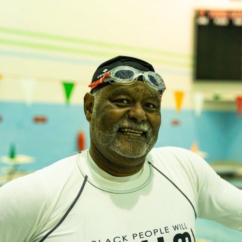 A Making Waves recipient gets ready for the indoor pool with goggles on his head.