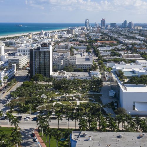 Aerial view shows the park surrounded by a cityscape with the ocean in the background.
